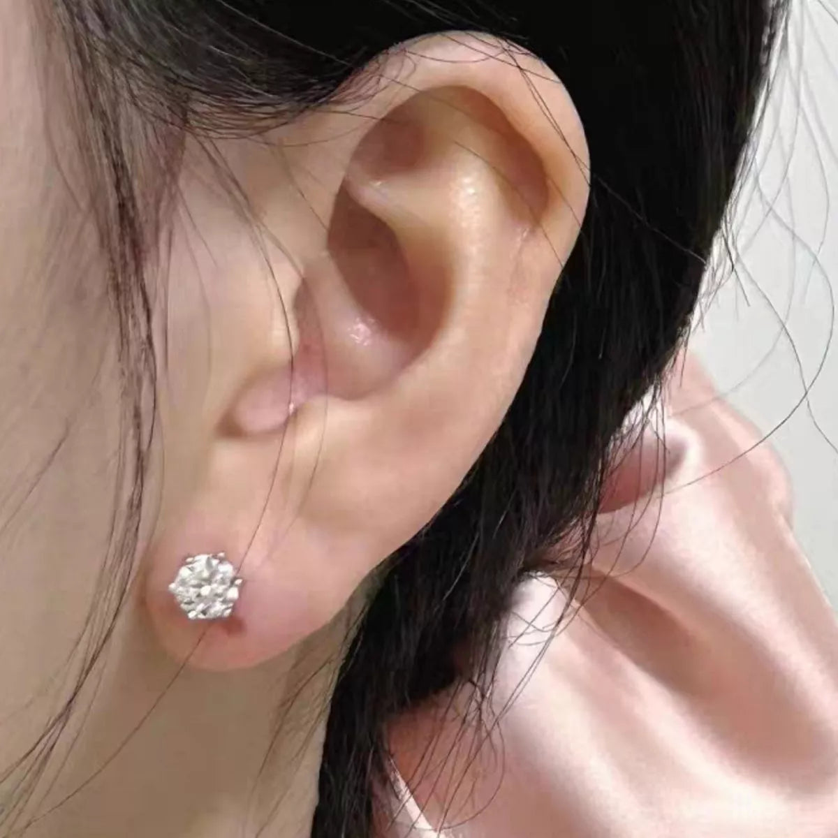 Close up of a single moissanite stud earring