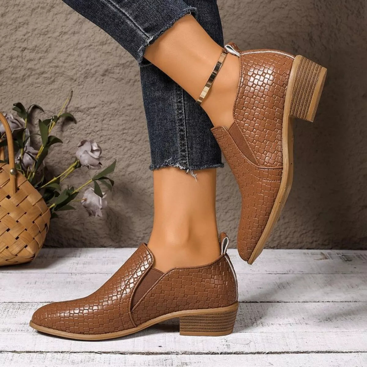 Brown point toe block heels ankle boots pair standing together