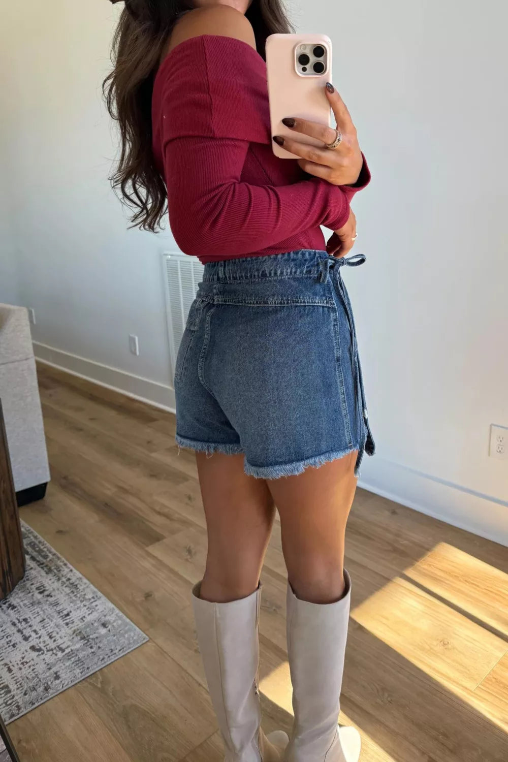 Medium wash wrapped tie waist denim skort full length view