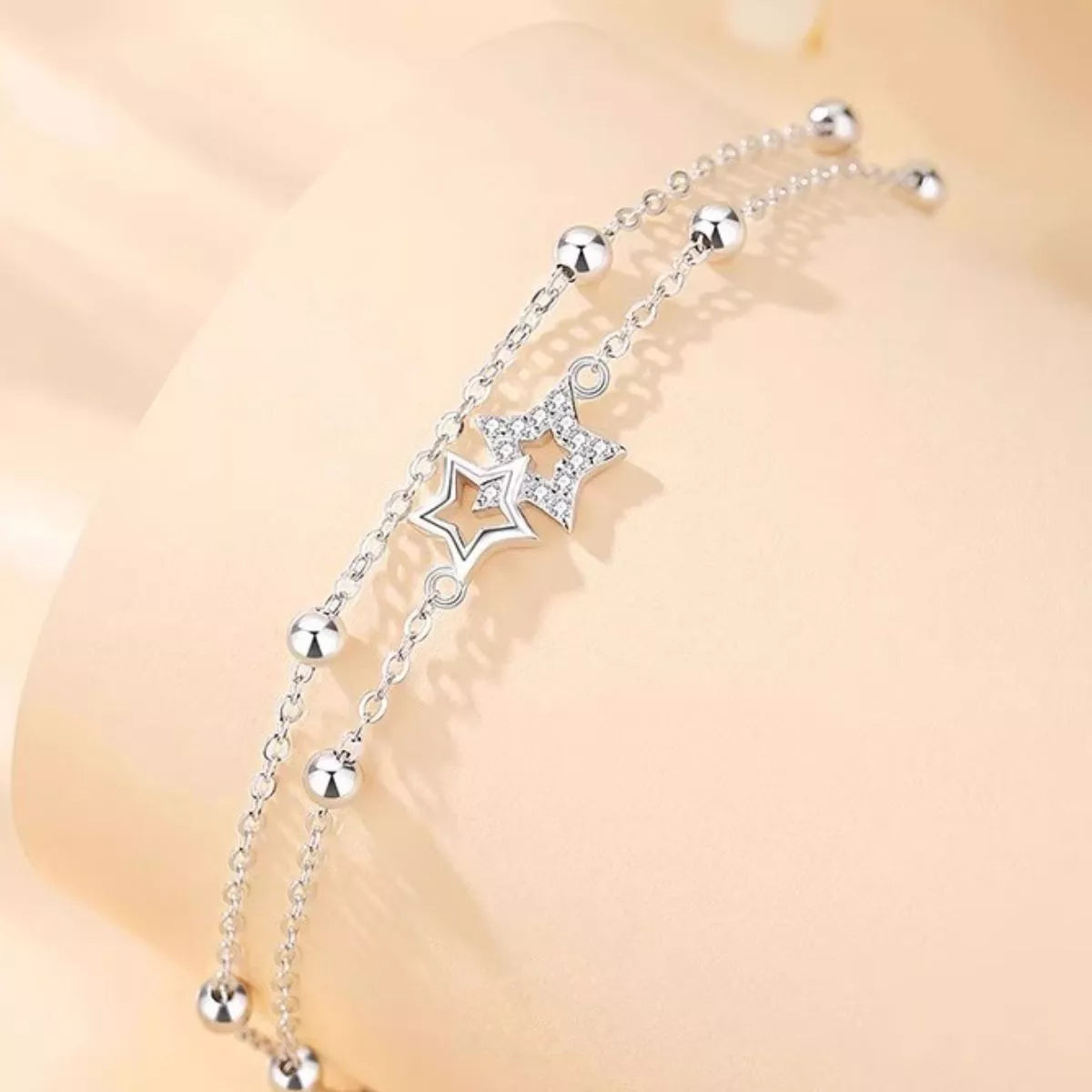 Sterling silver star bracelet shown worn on the wrist