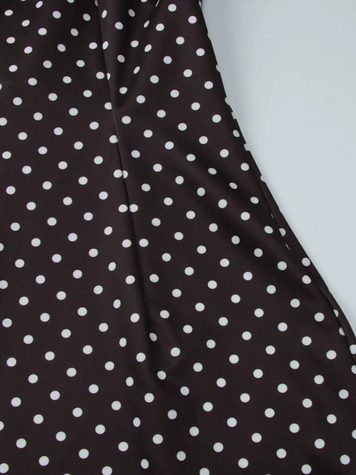 Polka dot mini dress laid flat showing silhouette