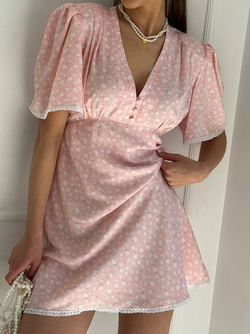 Blush pink V neck puff sleeve mini dress shown on a model