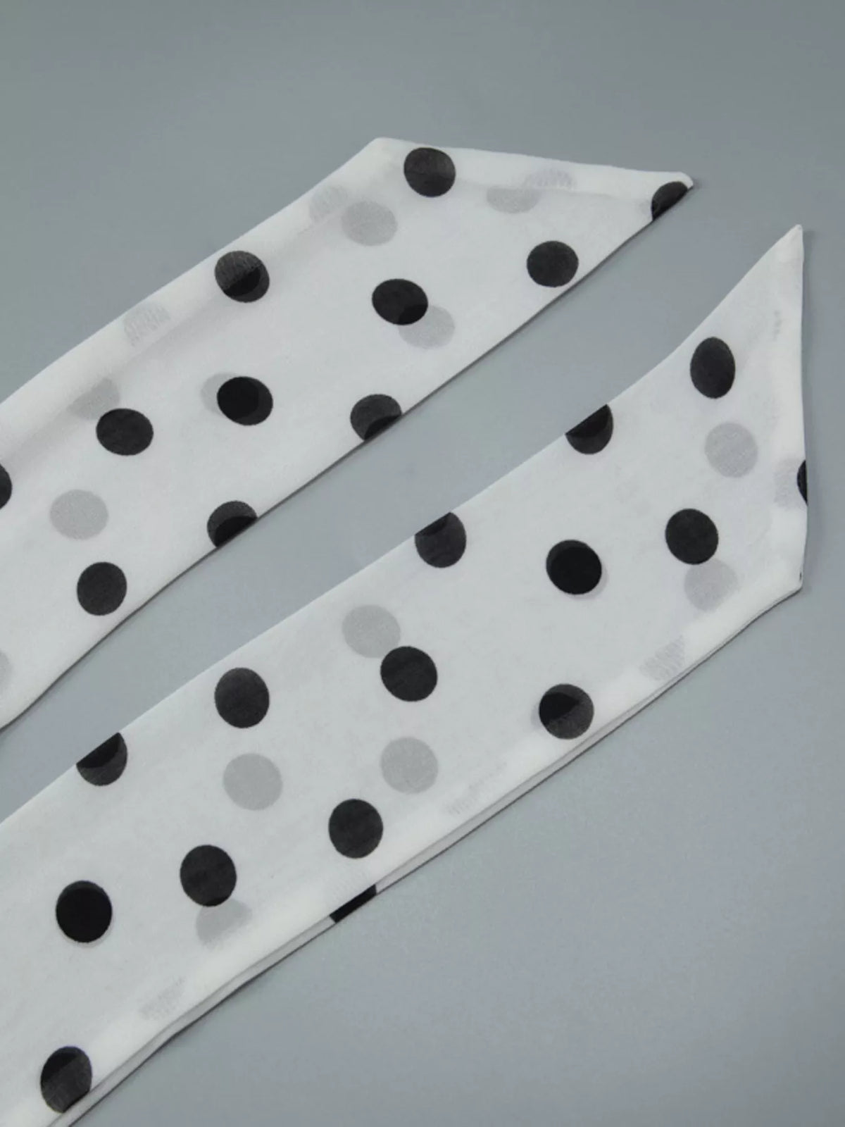 Movement shot of the white polka dot ruffle dress