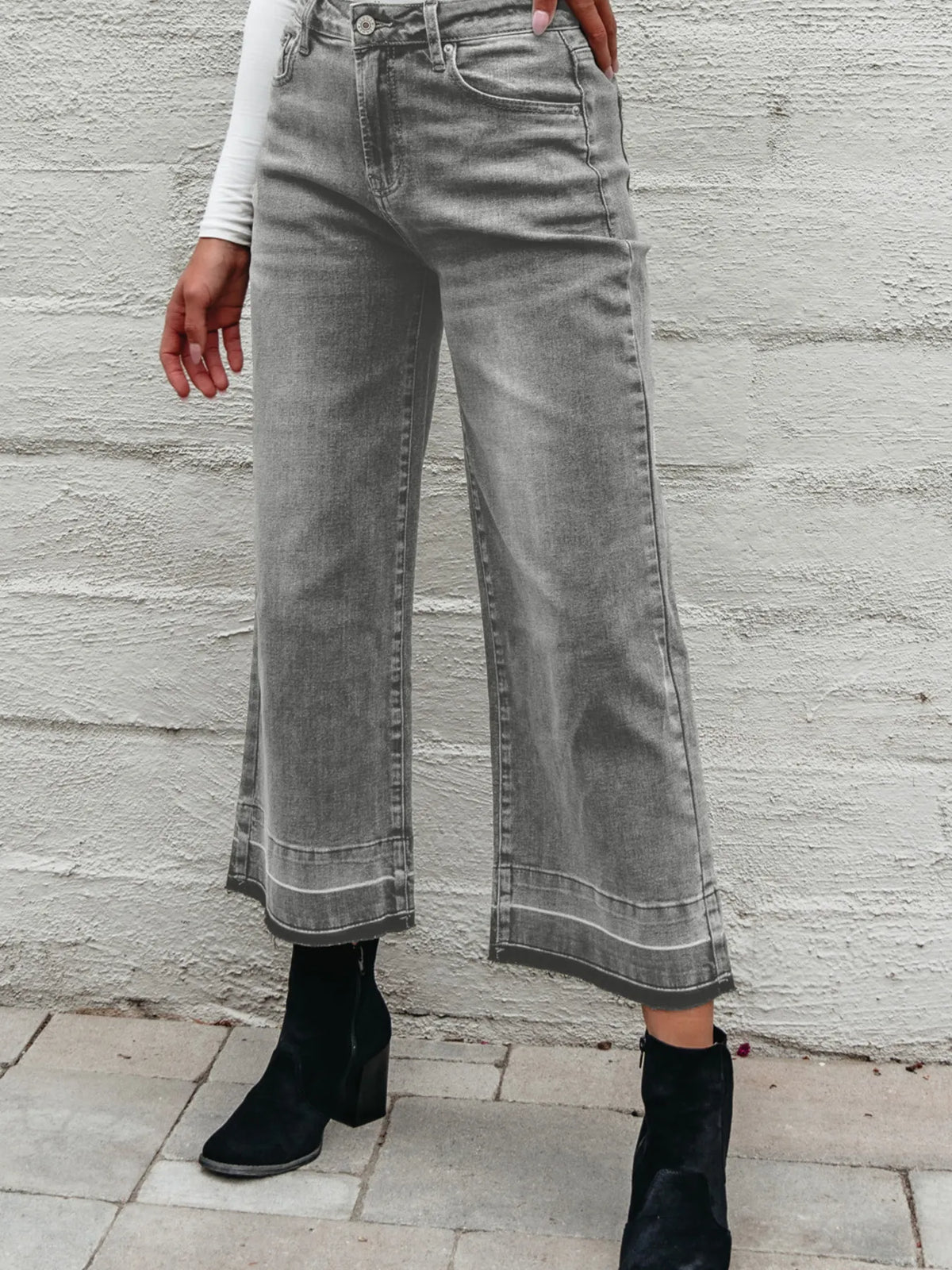 Model posing in high waist wide leg jeans