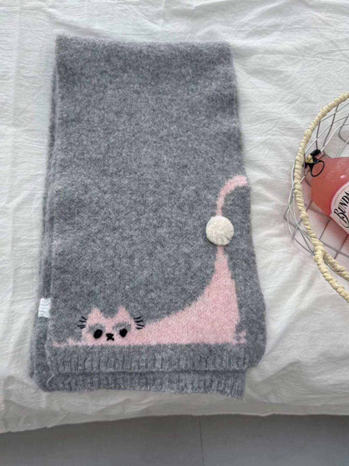 Knitted cat scarf looped around the neck
