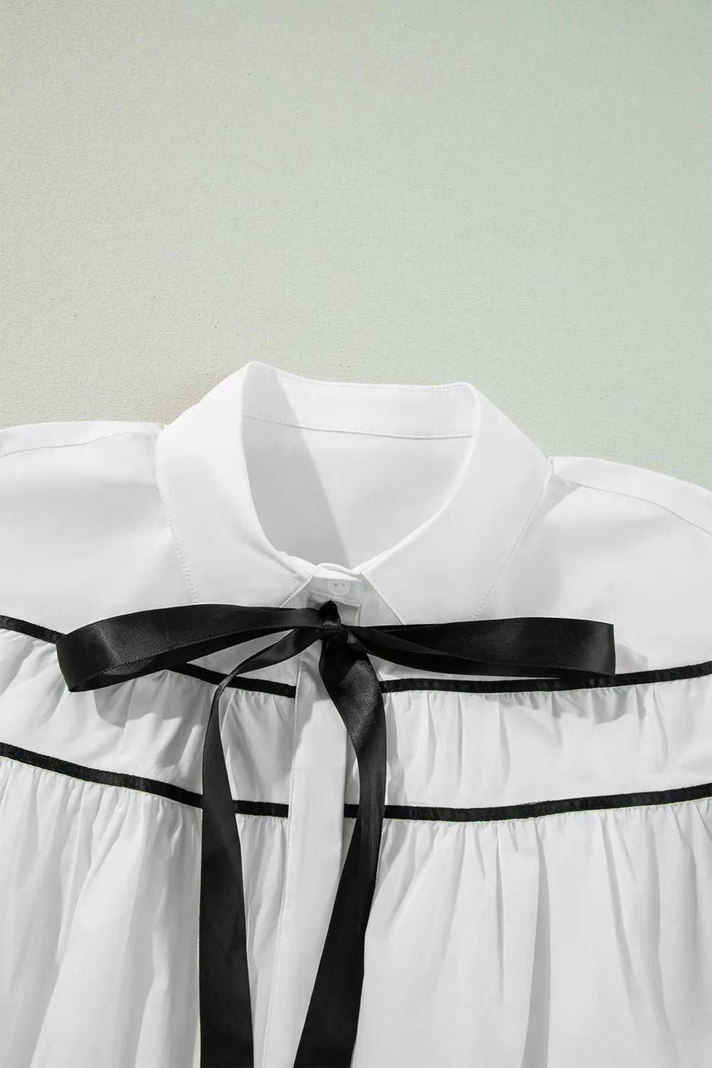White flounce sleeve shirt side profile