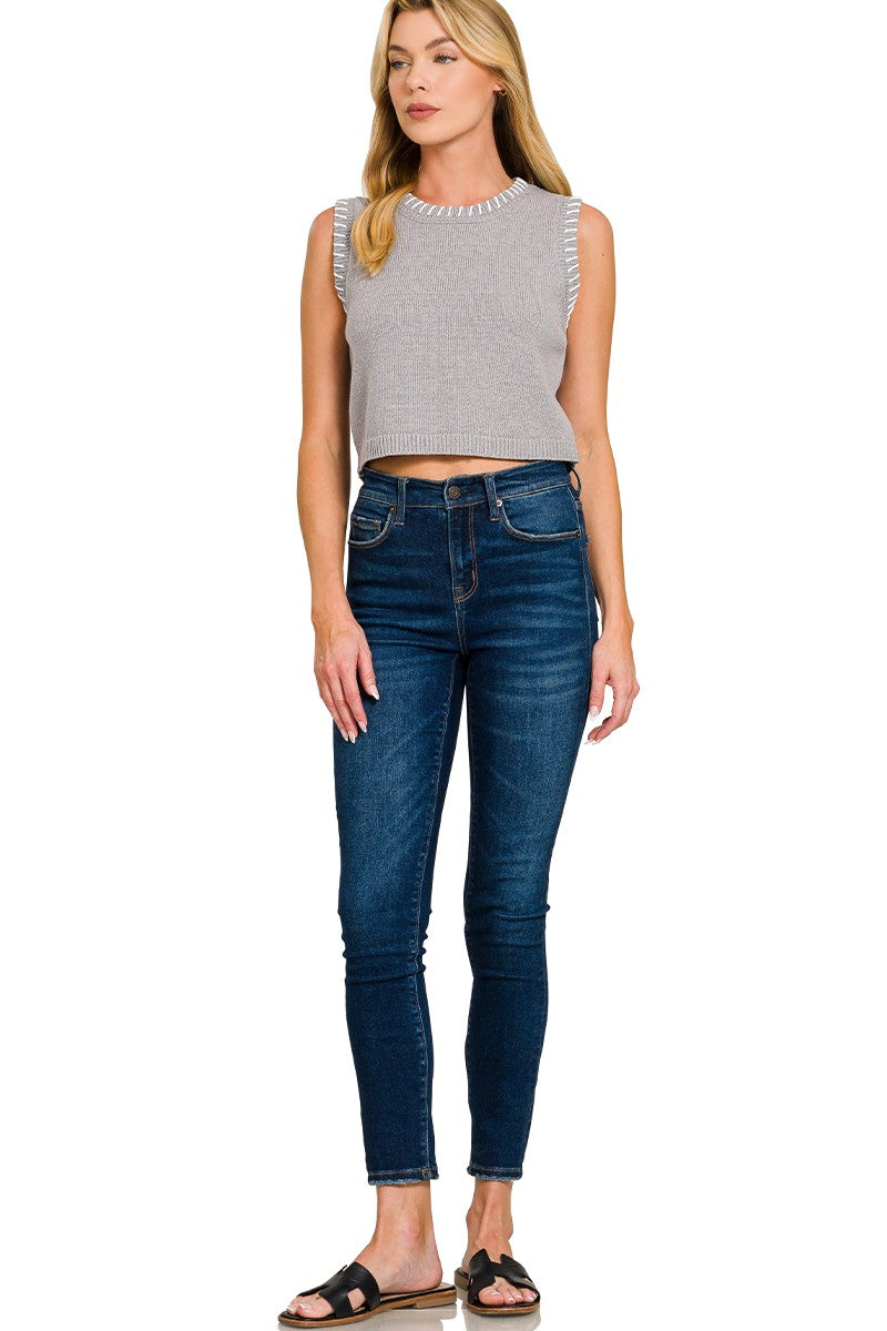 Cropped sweater vest styled over shirt