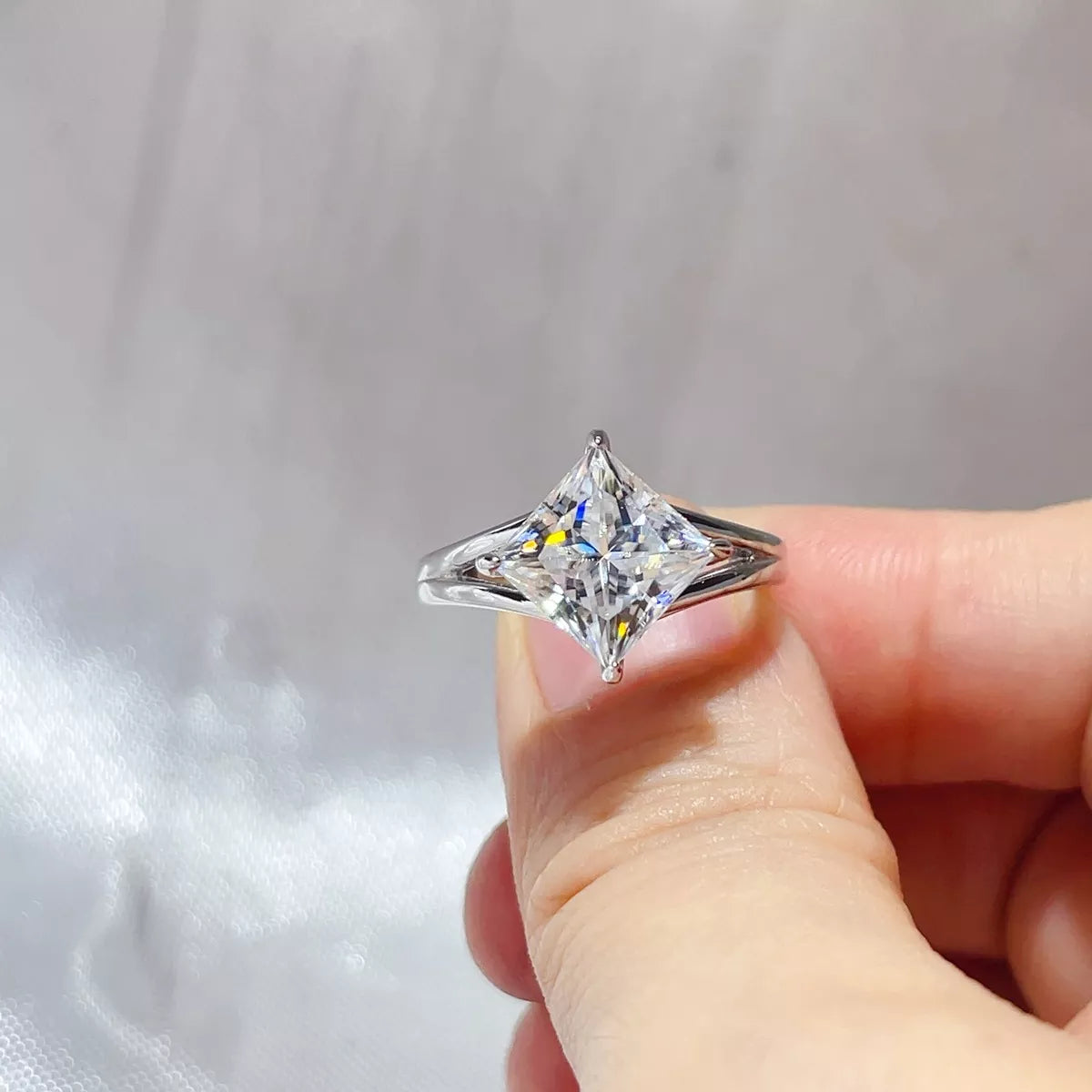 Sterling silver moissanite ring shown at an angle to display the setting