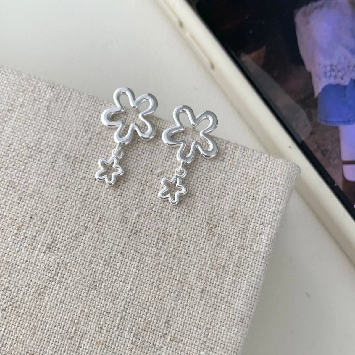 Sterling silver floral earrings displayed with the matching gift box