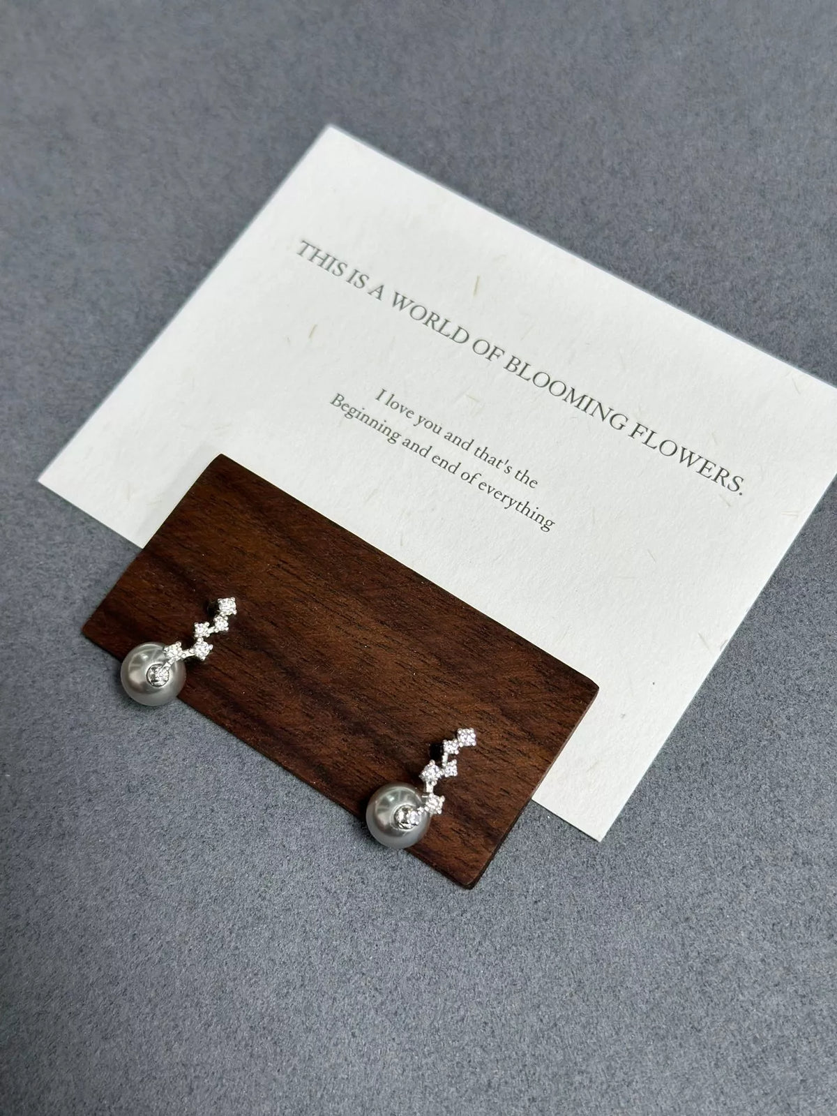 Sterling silver pearl and zircon earrings angled view