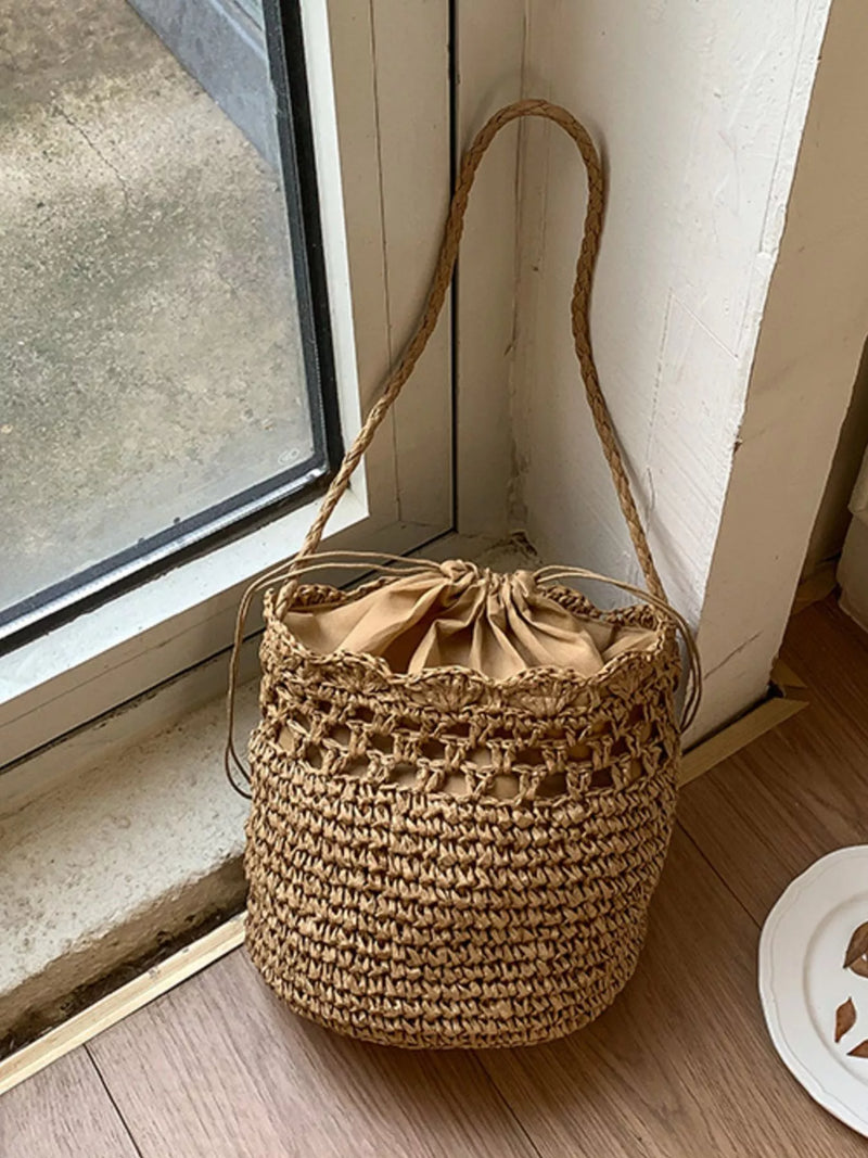 Khaki woven straw bucket bag front view