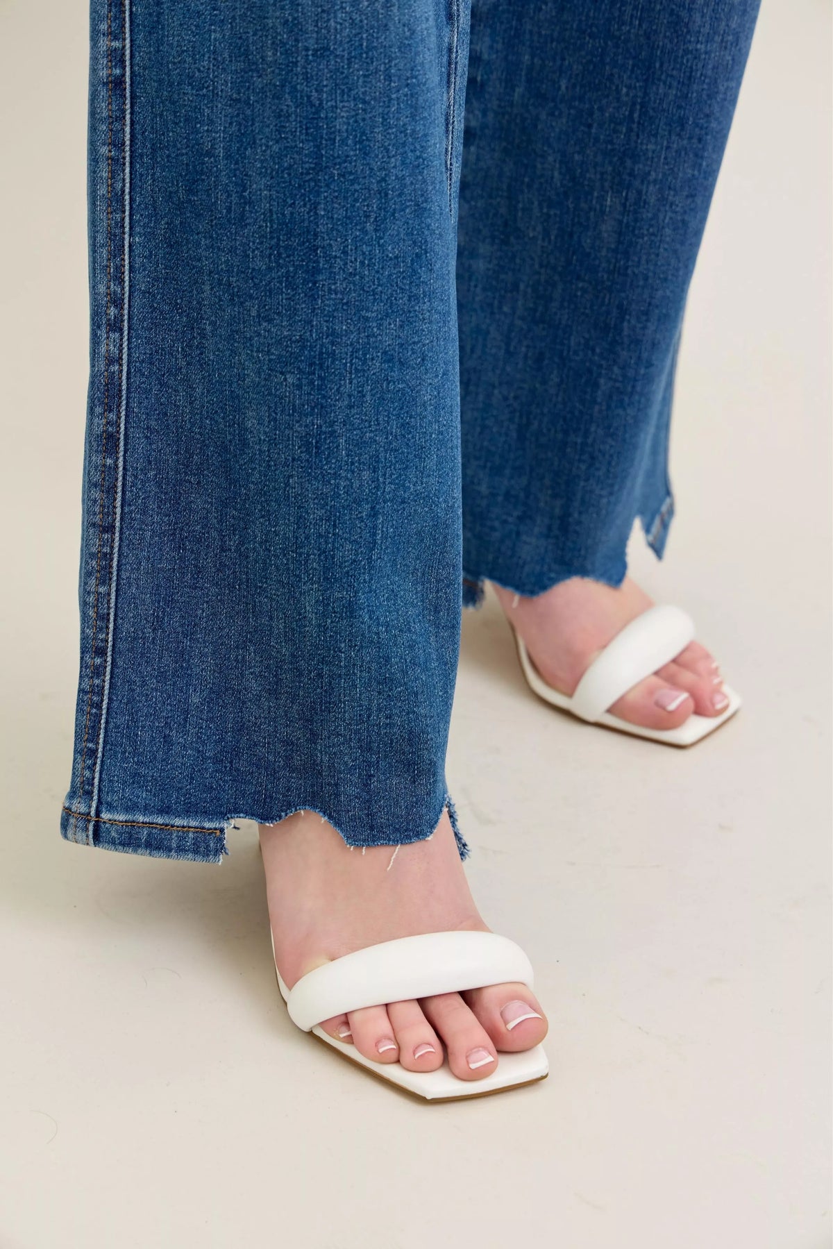 Medium wash wide leg jeans chew hem detail