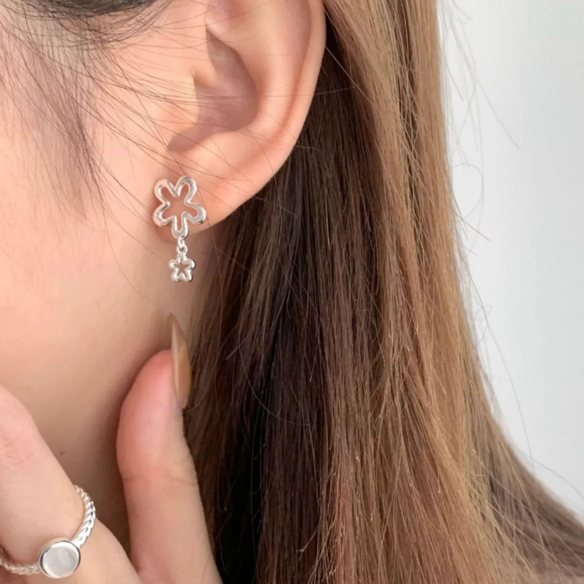 Side angle of the sterling silver flower drop earring showing the hook