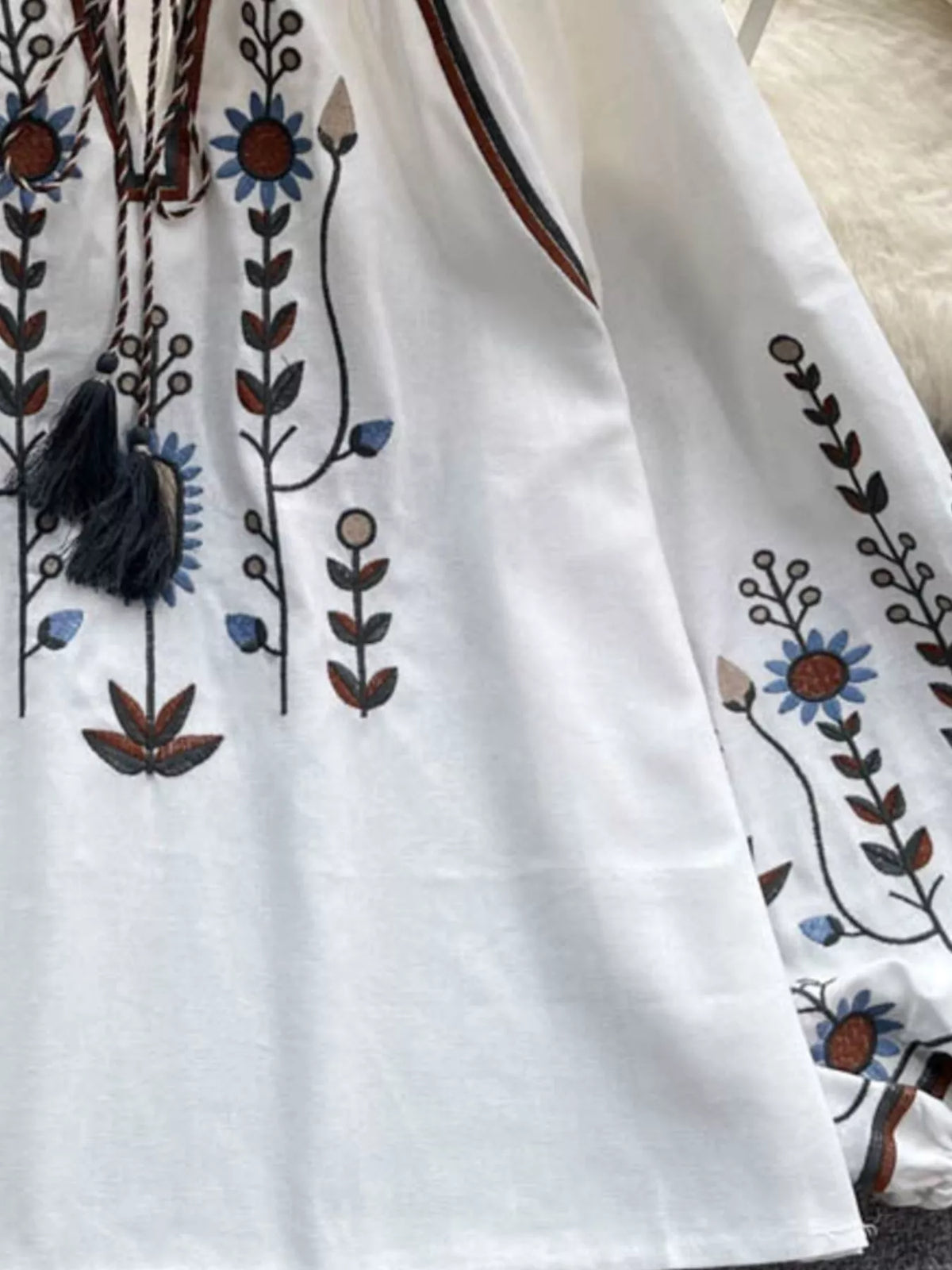 Boho embroidered tassel blouse worn open at the neck