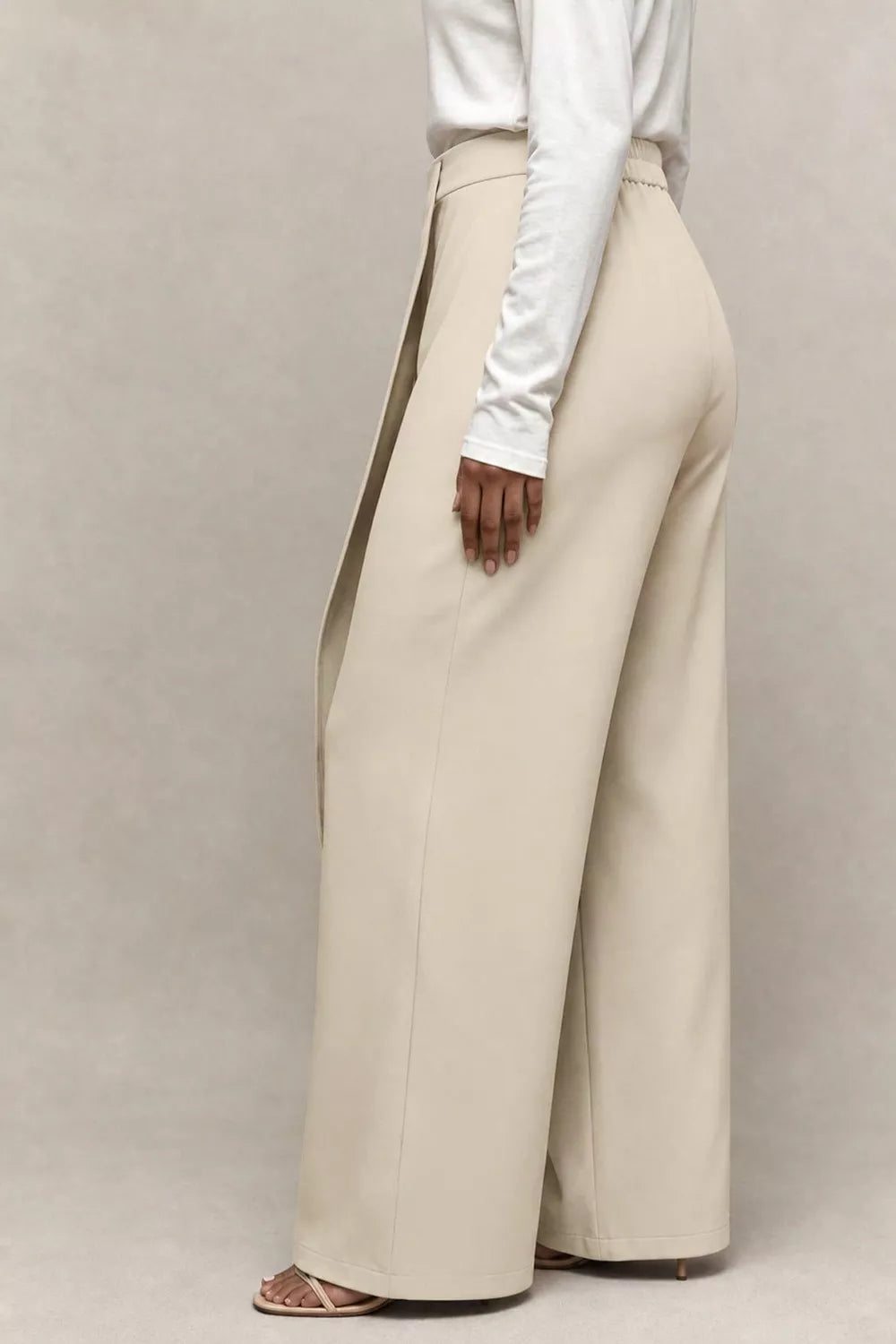 Close view of the wrap panel and high waist of the wide leg pants