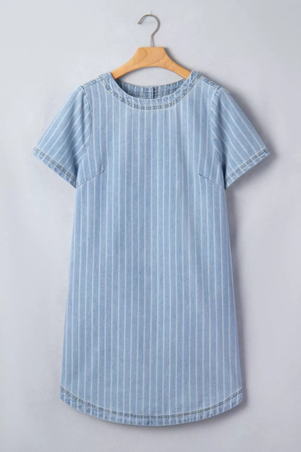 Light blue striped button back denim mini dress, close up detail