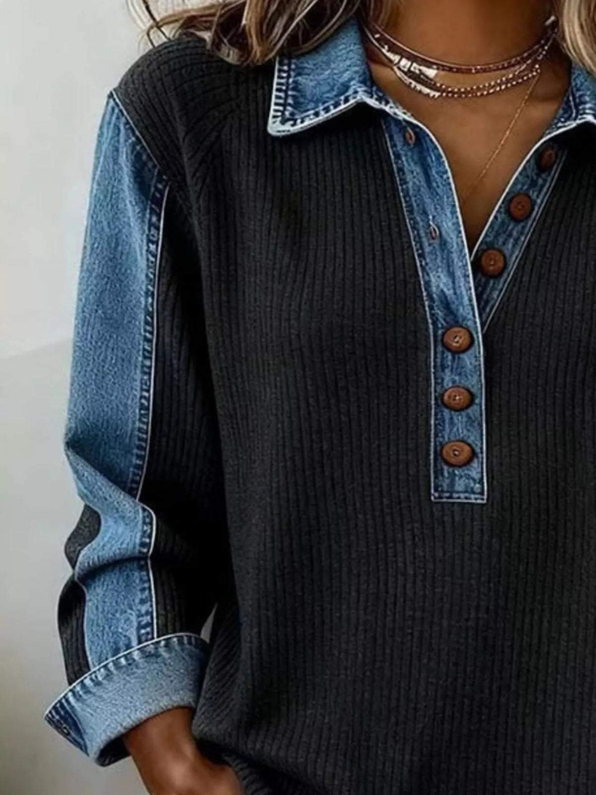 Model styling the sweatshirt with jeans