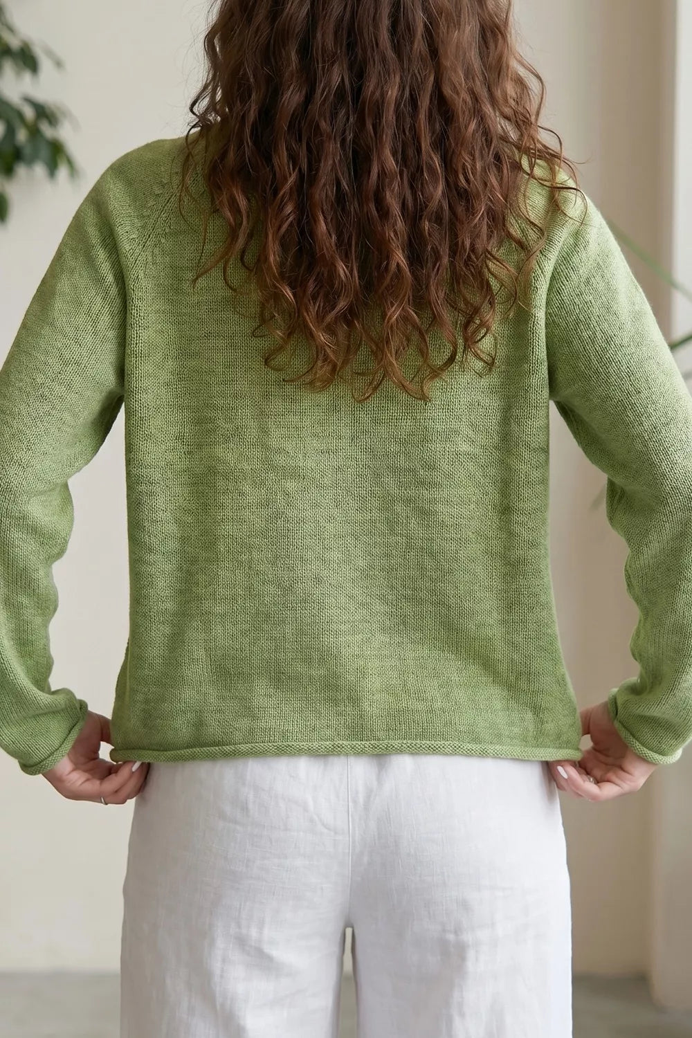 Sage green graphic knit sweater side view