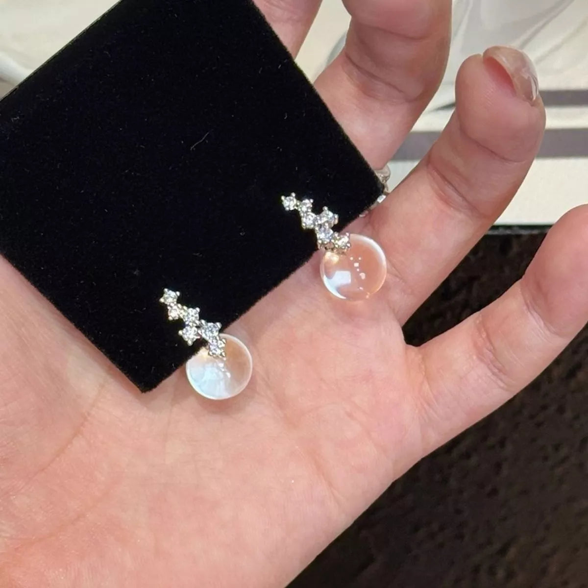 Crystal ball drop earrings in sterling silver close up detail