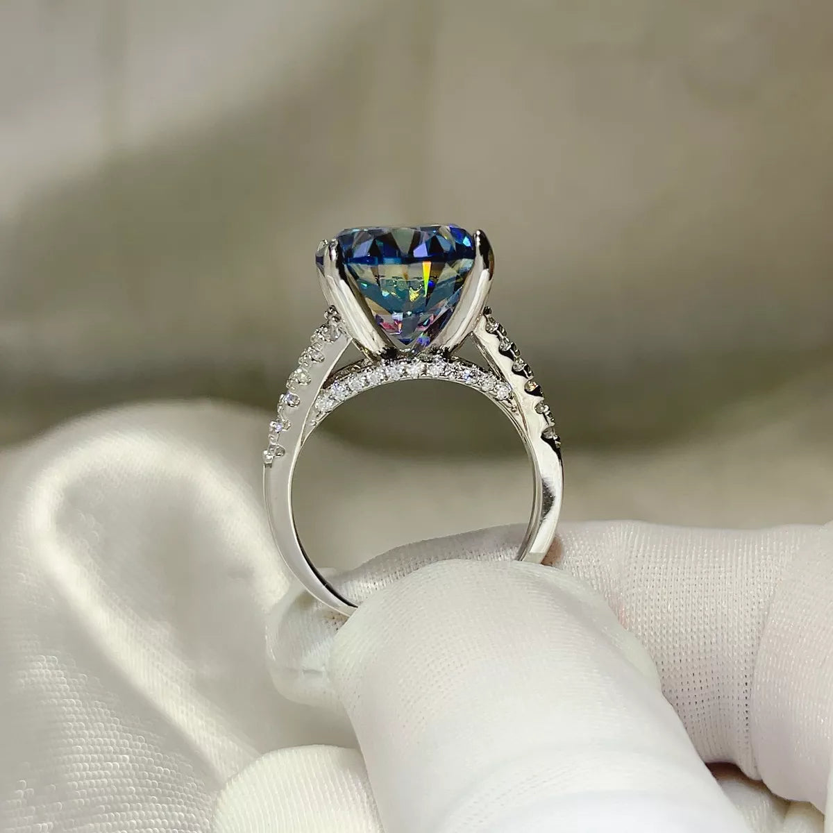 Blue moissanite ring worn on hand showing stone scale