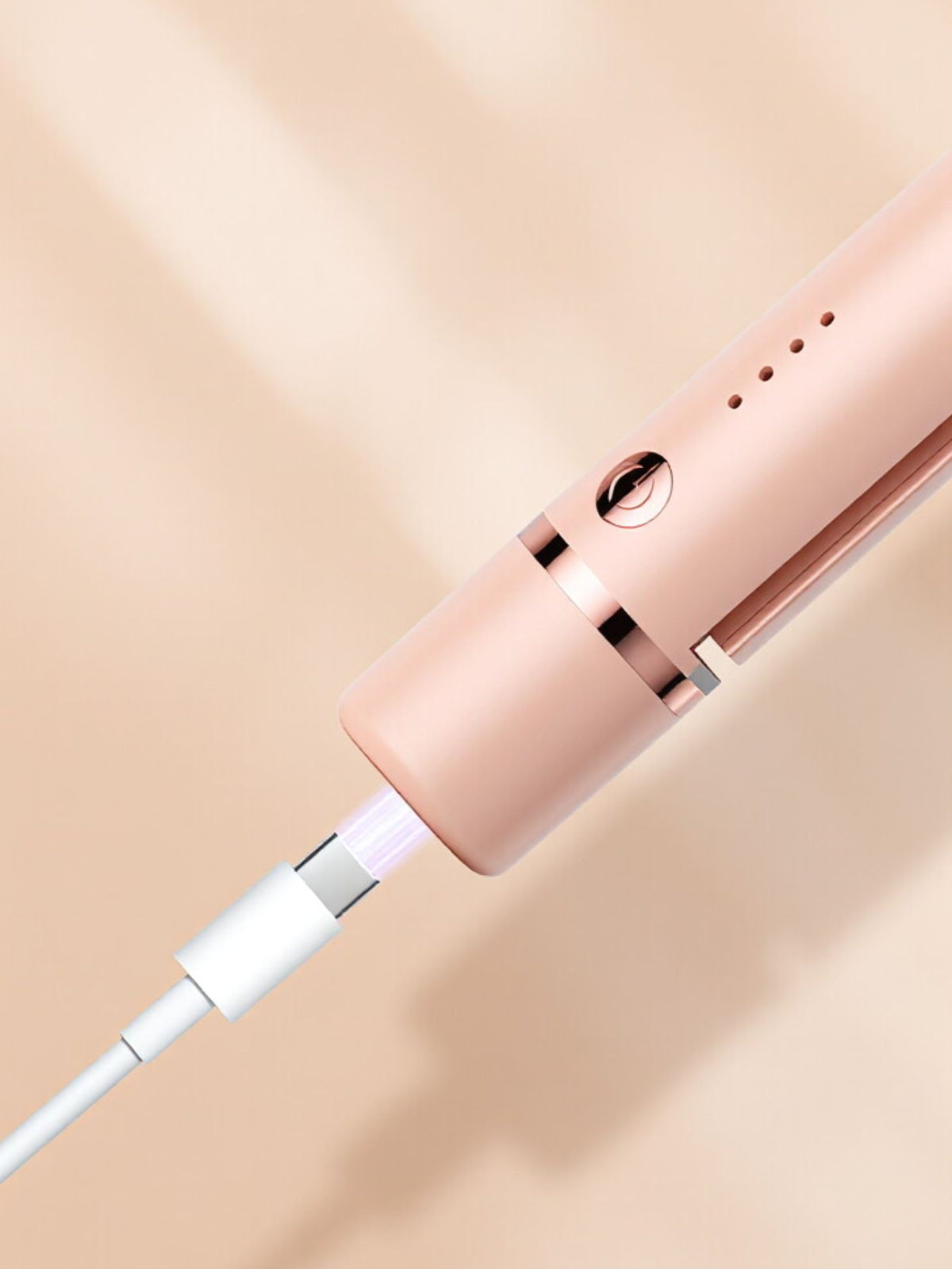Hair straightener in use on hair