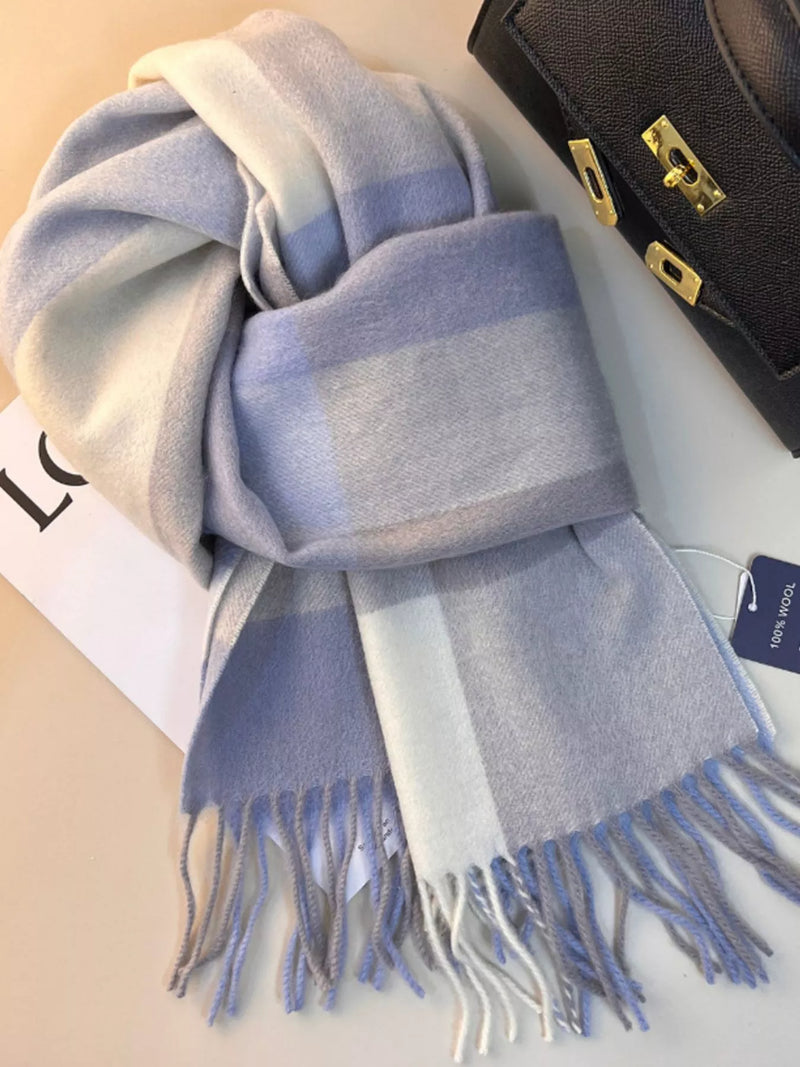 Plaid scarf with fringe draped over a coat