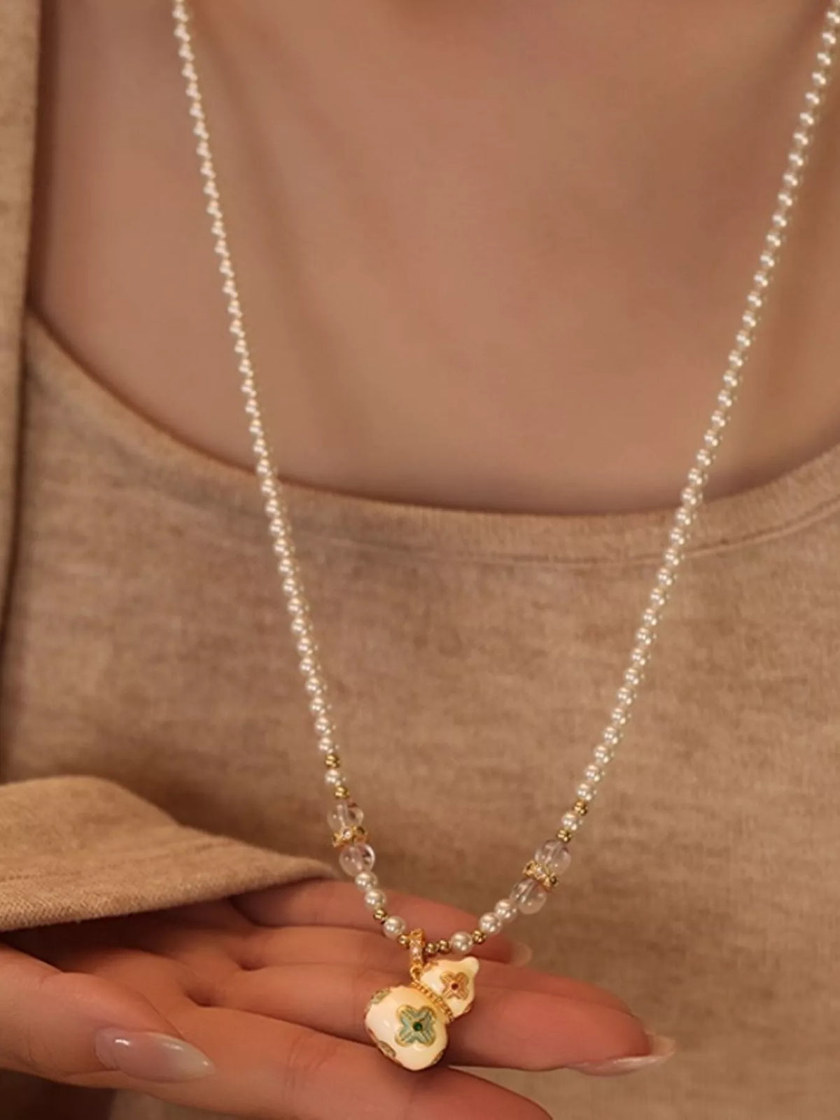 gold plated gourd pendant necklace flat lay