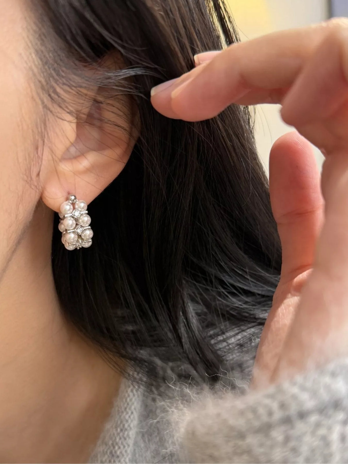 Pearl and zircon hoop earrings flat lay