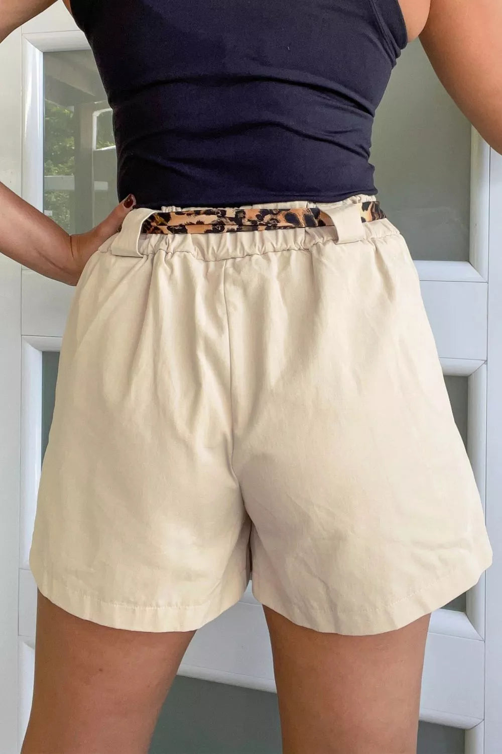Beige high waisted pleated shorts back view