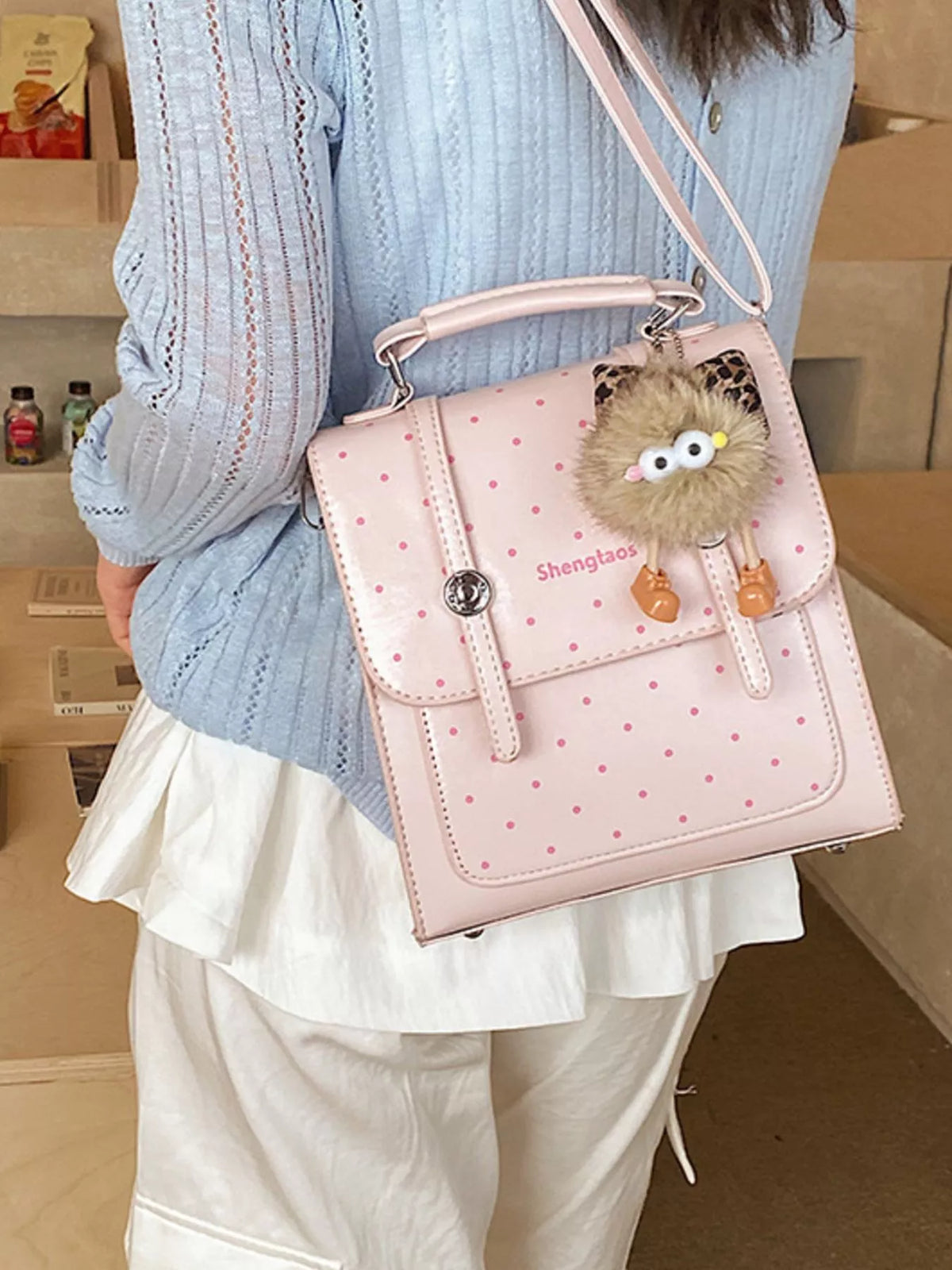 Blush pink polka dot mini backpack top handle close up