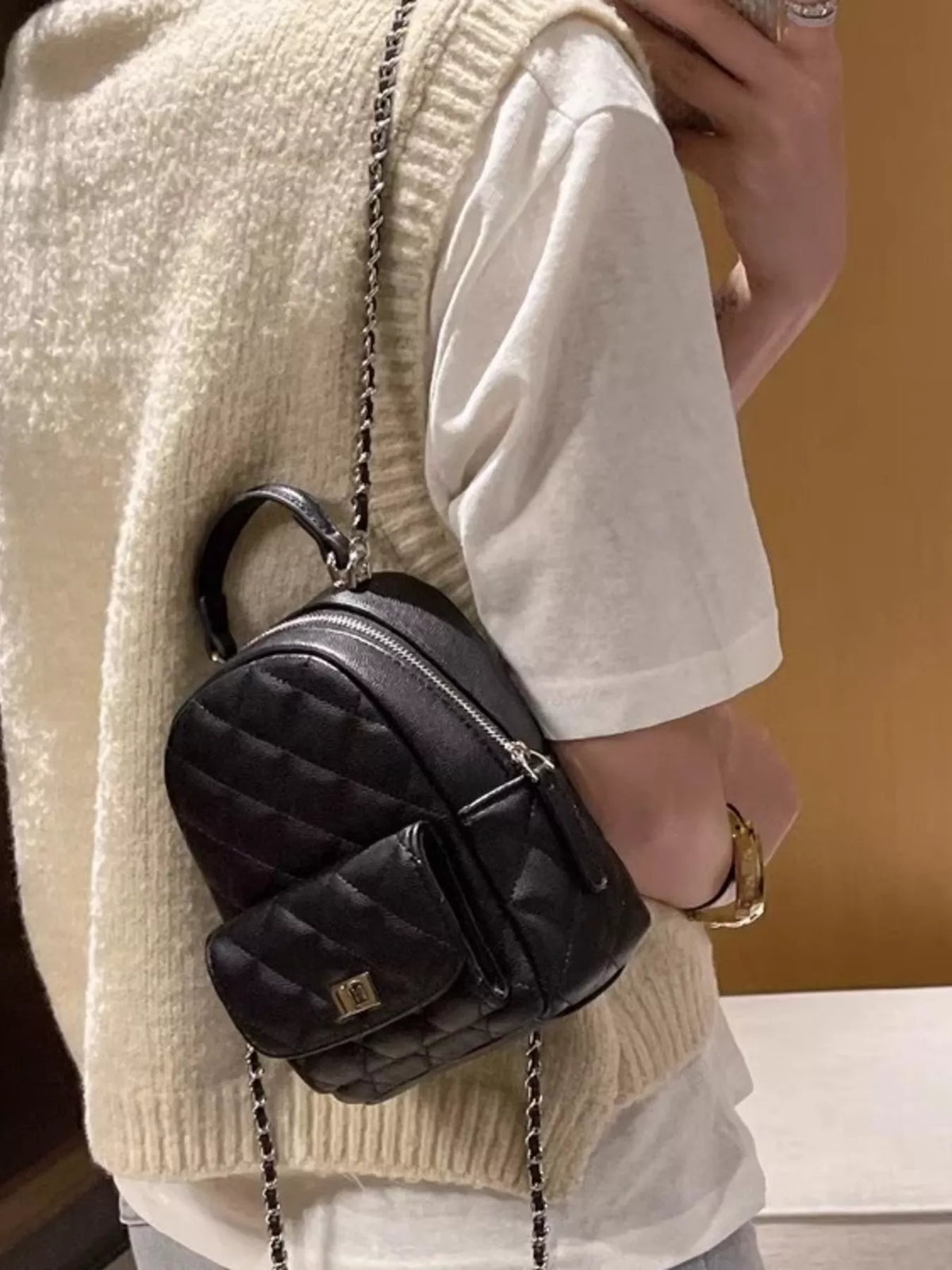 Quilted mini backpack held in hand