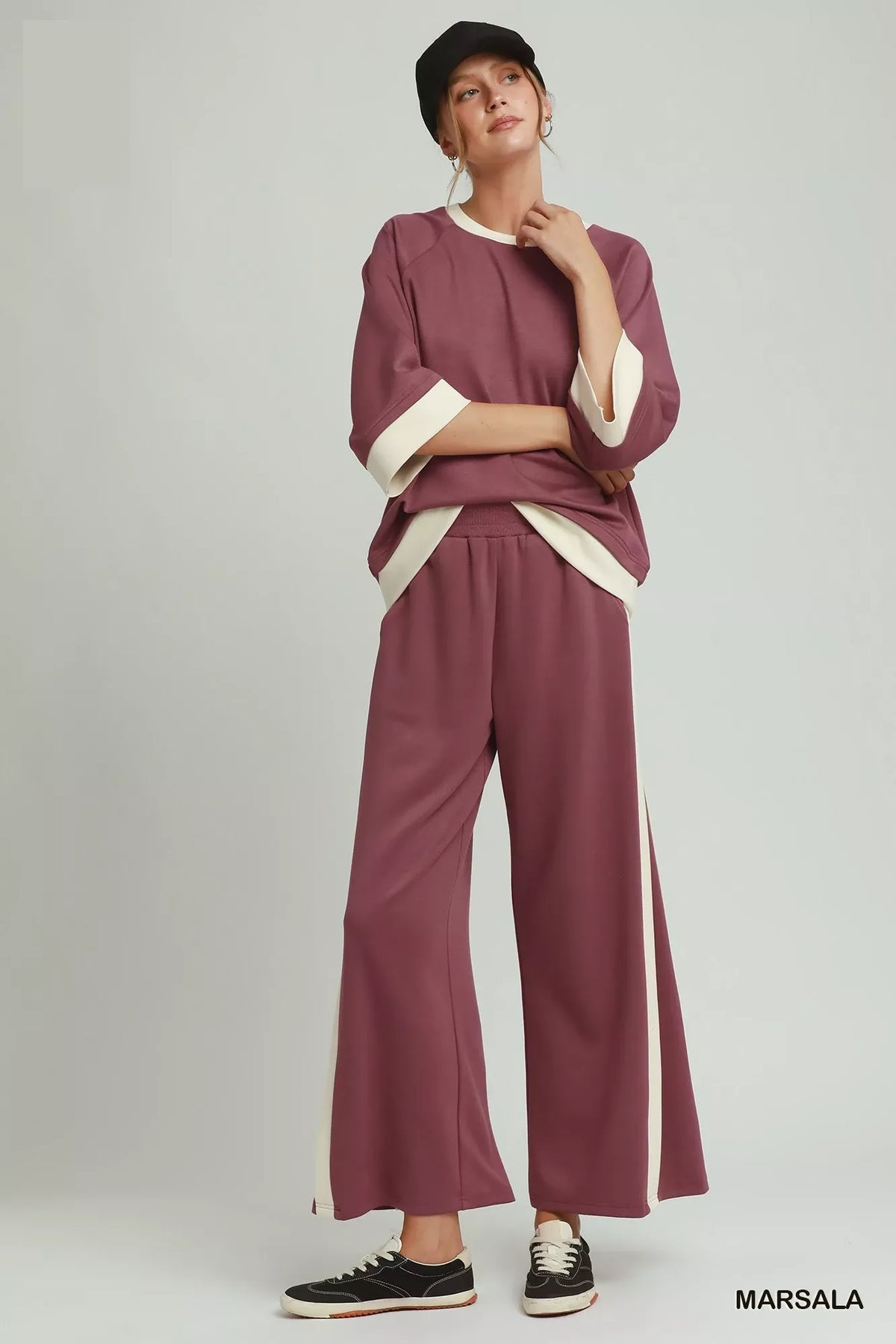Side view showing the contrasting vertical stripe on the straight leg pants
