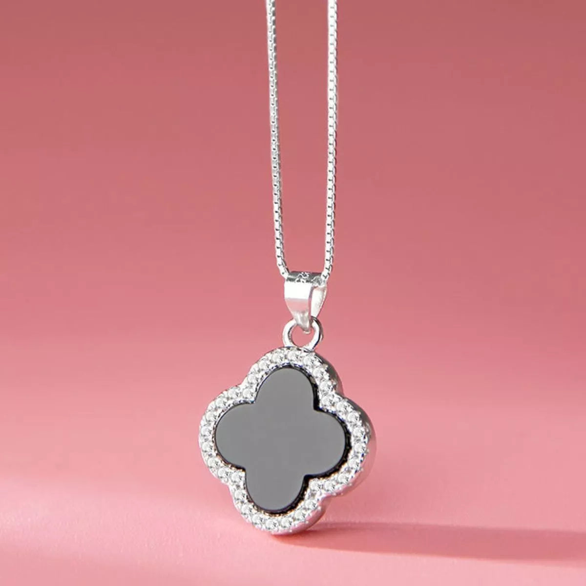 Close up of the agate clover pendant on the silver chain