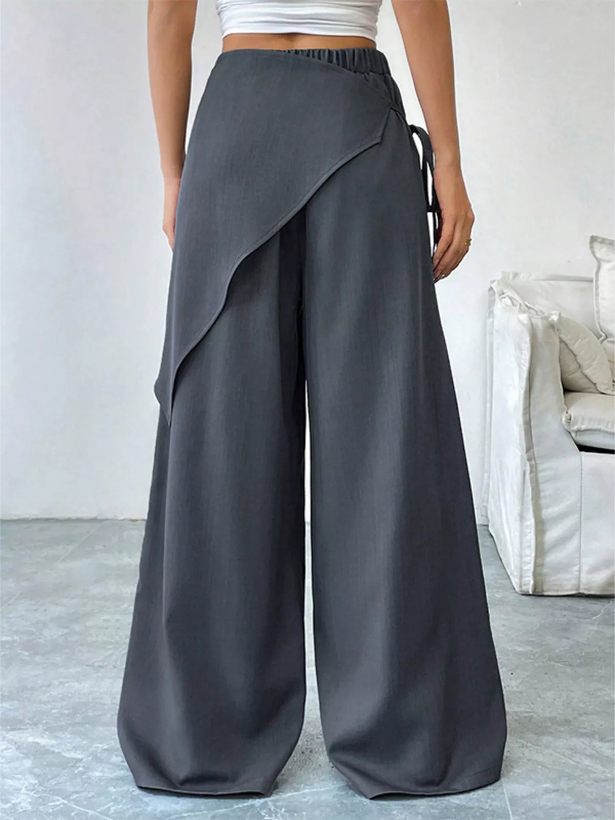 Waist and button closure detail on the wrap pants