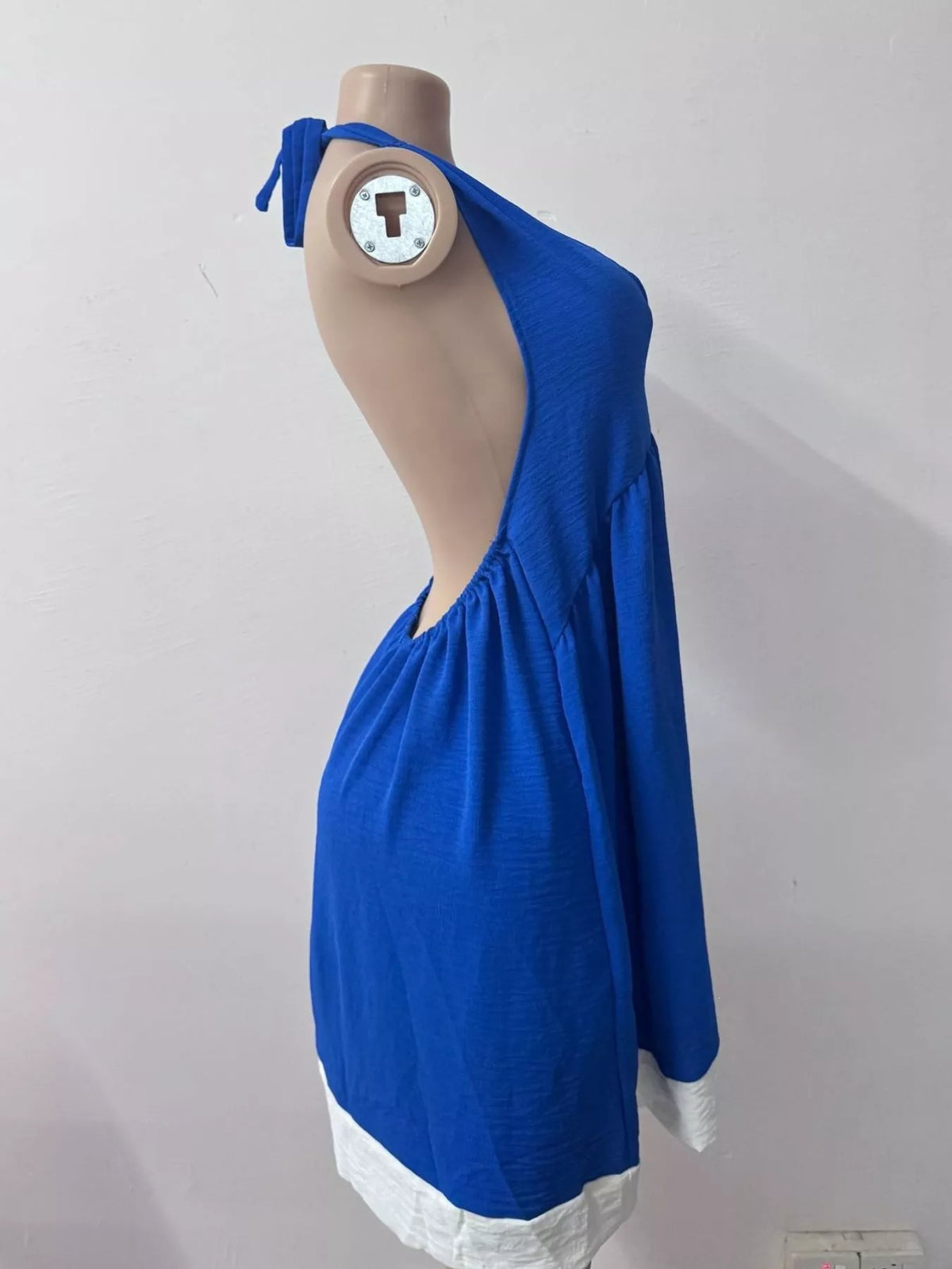 Backless dress seen at a three quarter angle