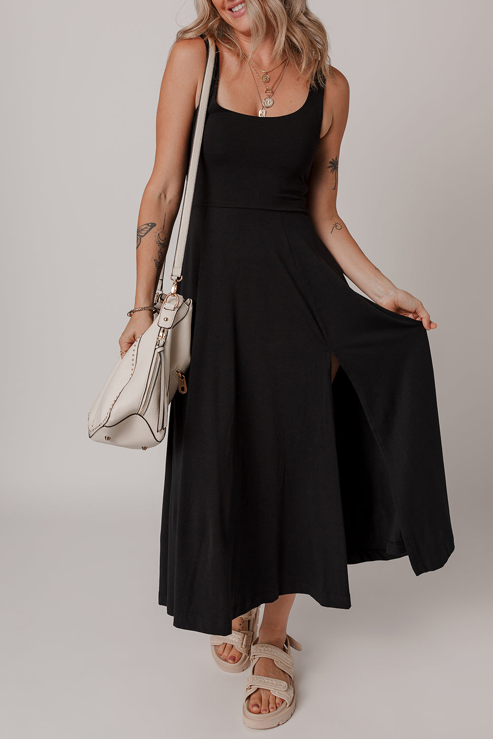 Sleeveless black scoop neck dress full length view