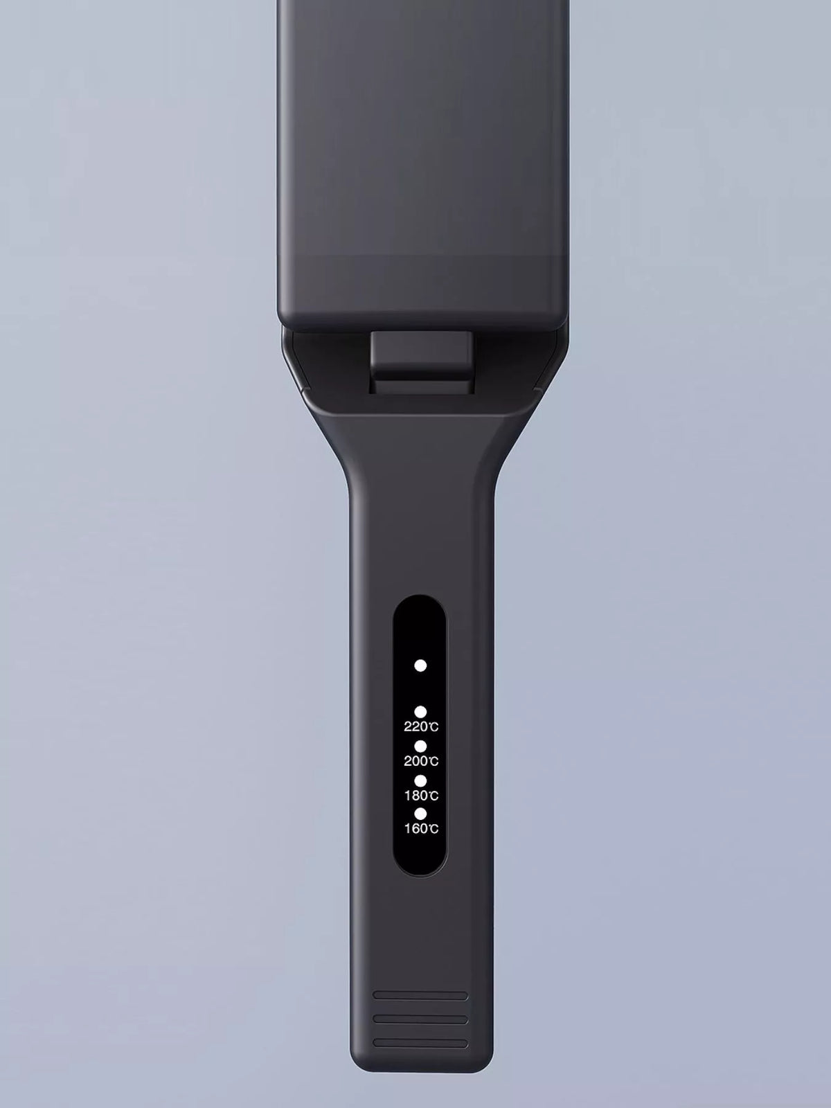 Hair straightener in use on hair
