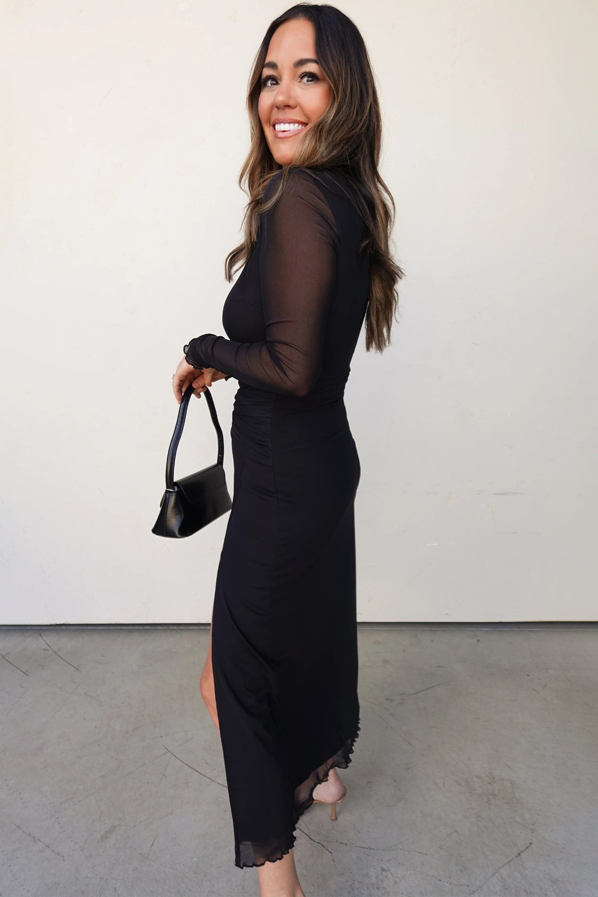 Back view of black sheer mesh long sleeve midi dress