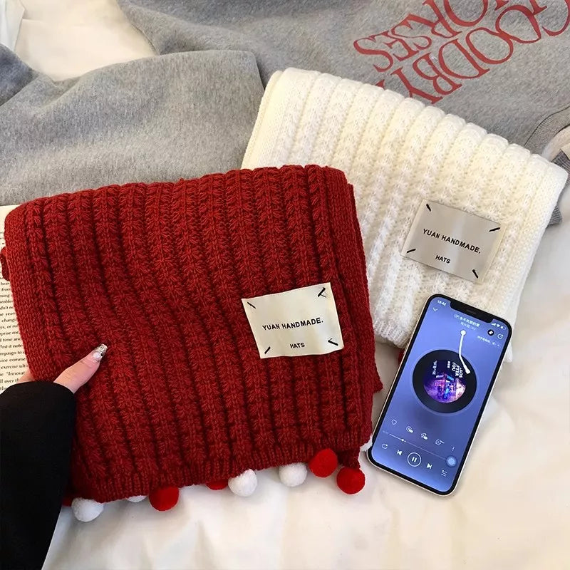 Close view of the knit and pom-pom detail