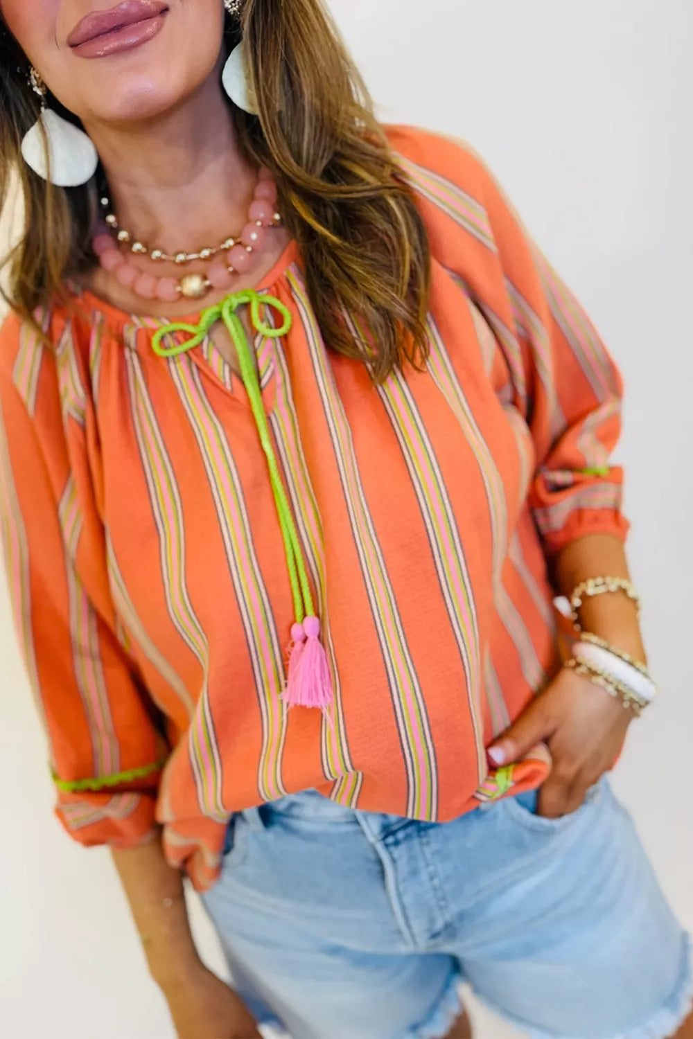 Cotton striped blouse shown with bracelet length sleeves