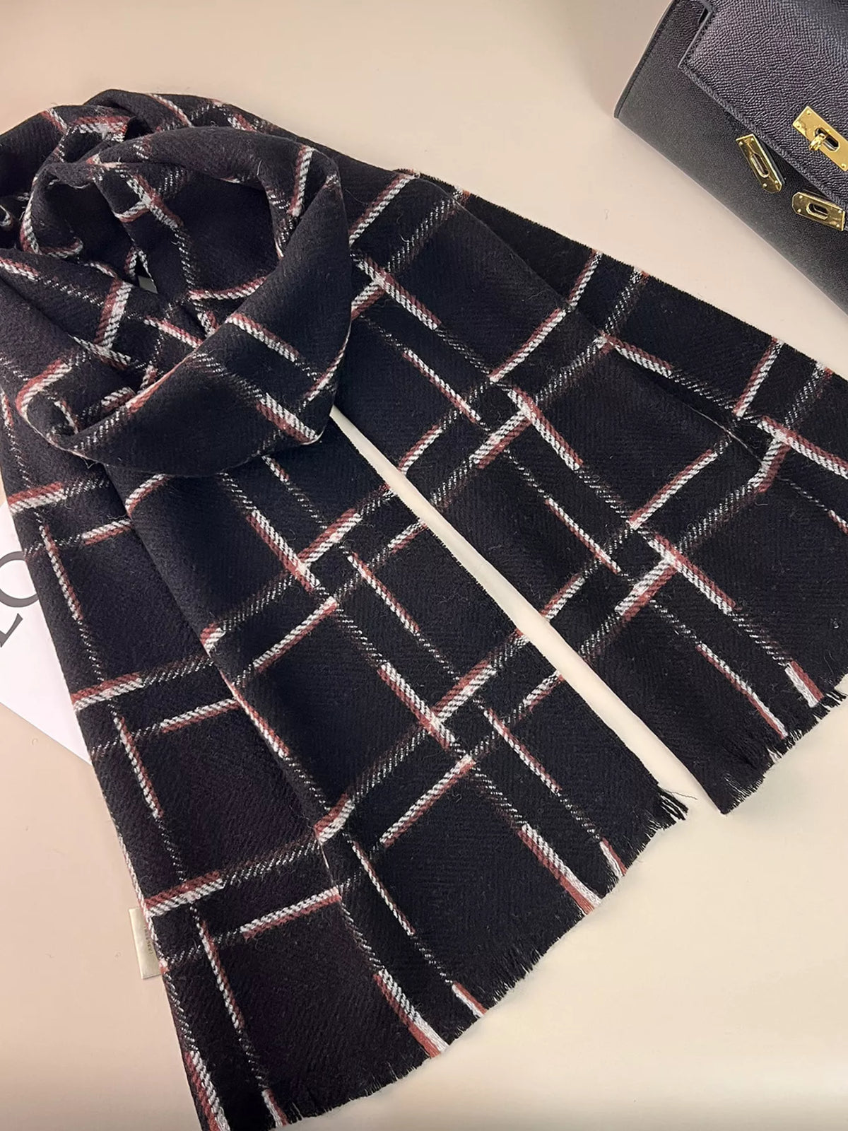 Cozy wool plaid scarf knotted at the throat