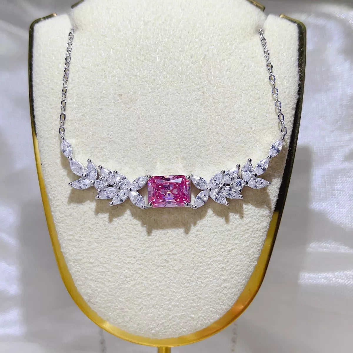 Close up of pink moissanite stone in silver setting