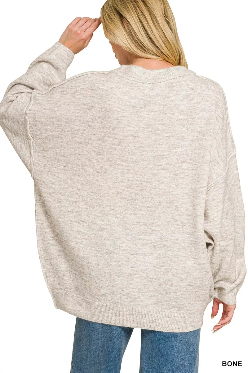 Oversized crew neck melange sweater styled on model