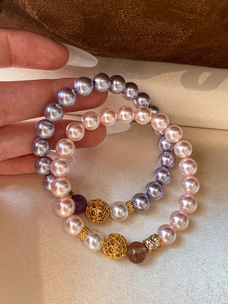 Pearl beaded bracelet with gold accents, styled view