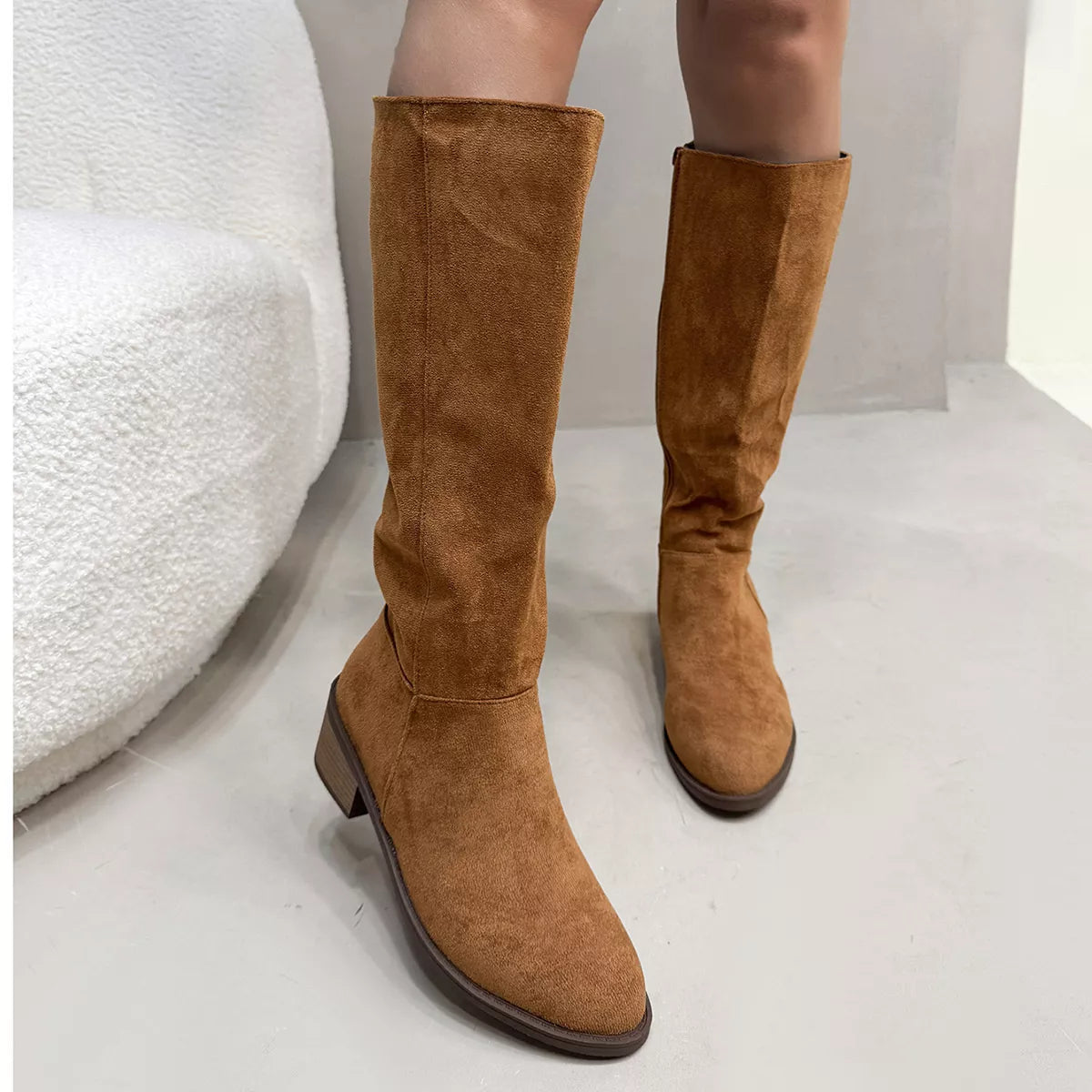 Knee high boots worn with denim