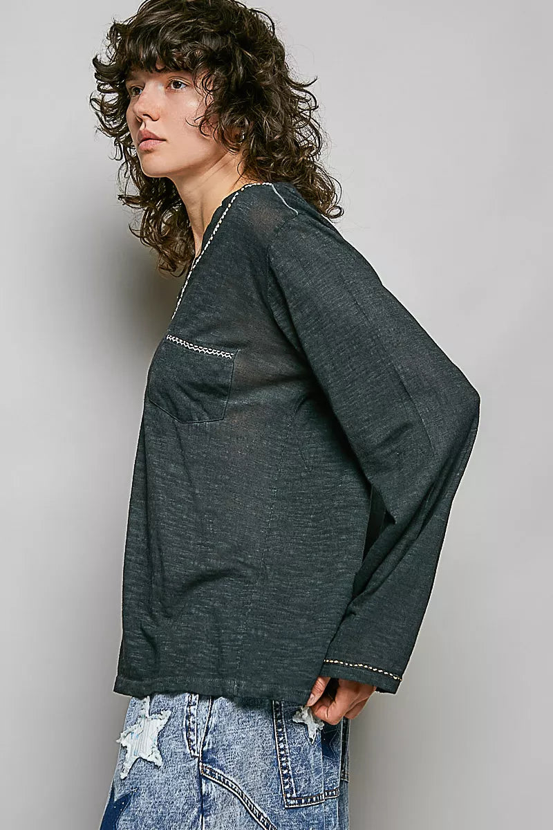 Black cotton knit long sleeve top with V neckline angled view
