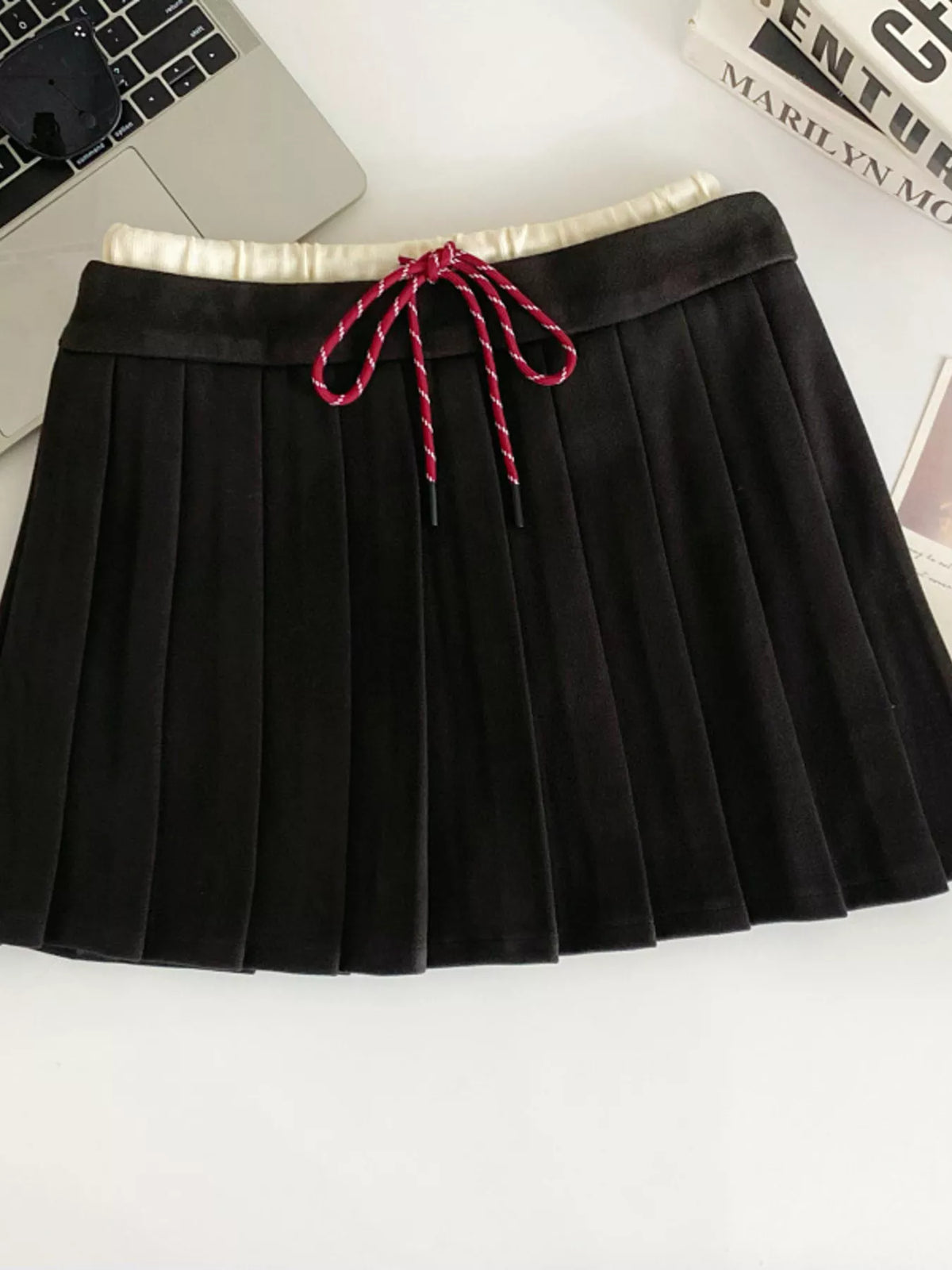 Pleated mini skirt on model