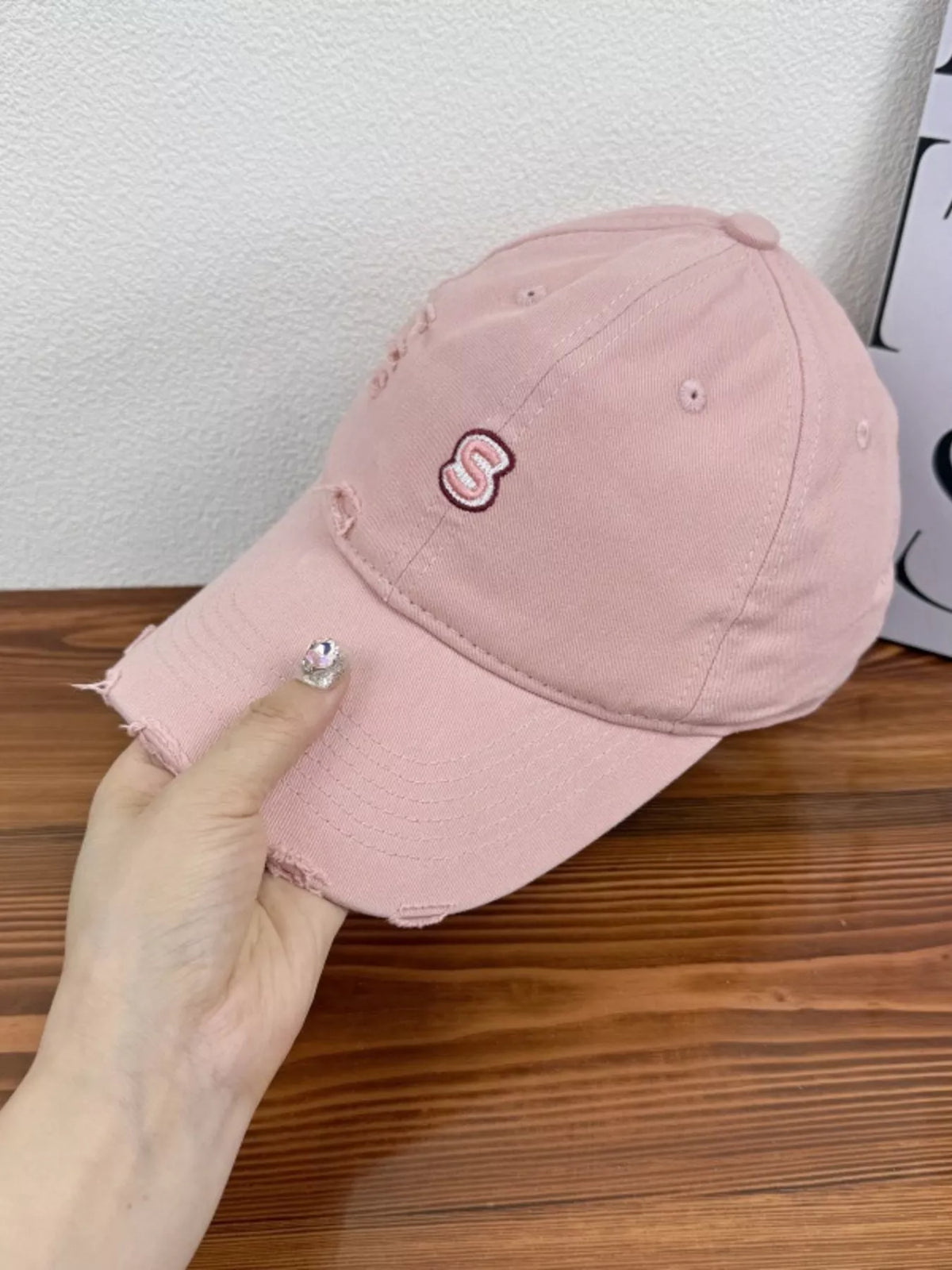 Distressed cotton cap shown from the side