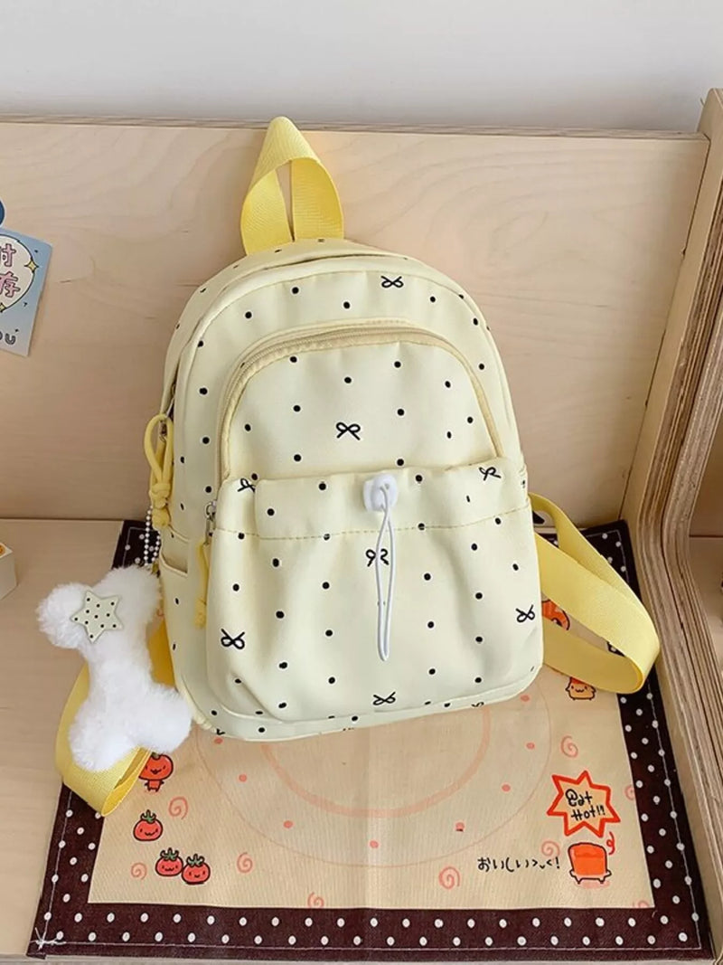 Pastel yellow polka dot mini backpack front view