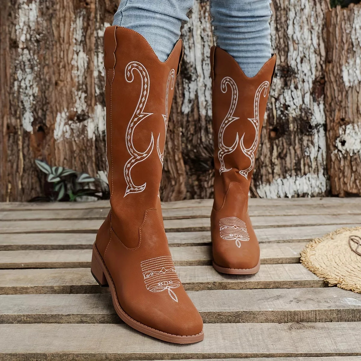 Embroidered round toe block heel boots angled pair